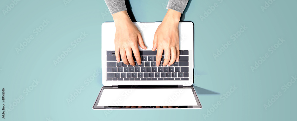 Person using a laptop computer from above