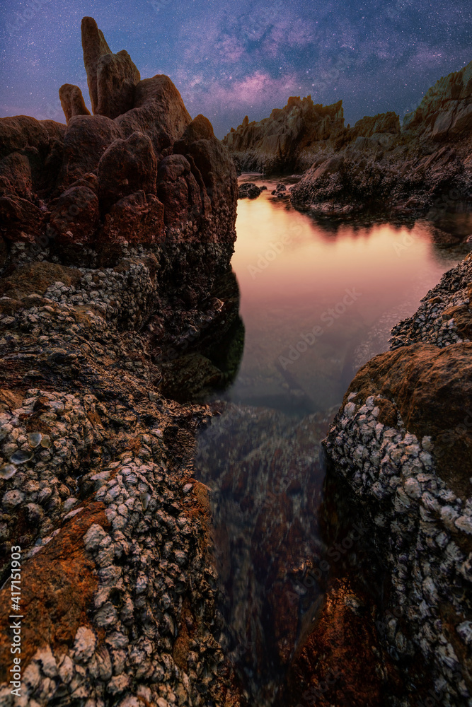 Seascape during sunset or sunrise light of nature. Amazing Natural seascape with rocks in the foregr