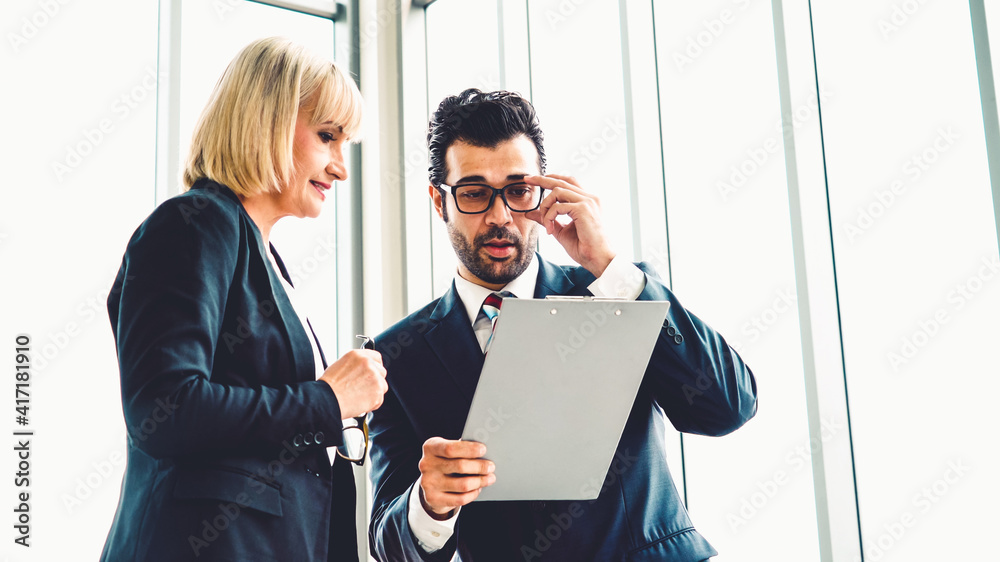 Two business people talk project strategy at office meeting room. Businessman discuss project planni