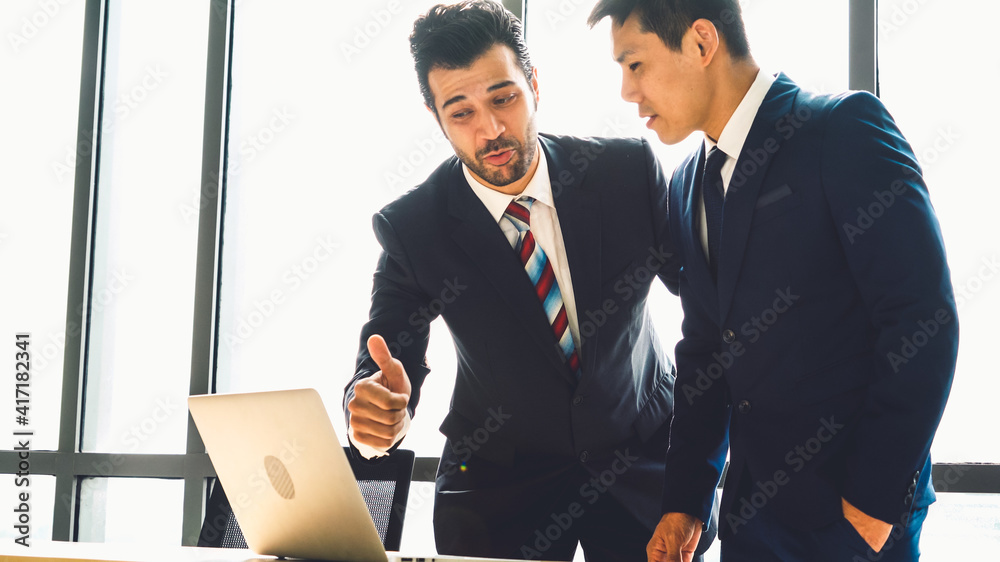 Two business people talk project strategy at office meeting room. Businessman discuss project planni