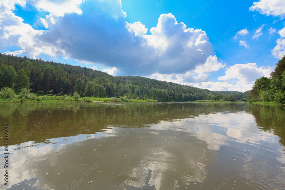 Colorful landscape with mountains and a beautiful calm river in Russia. River Ay. Summer, river raft