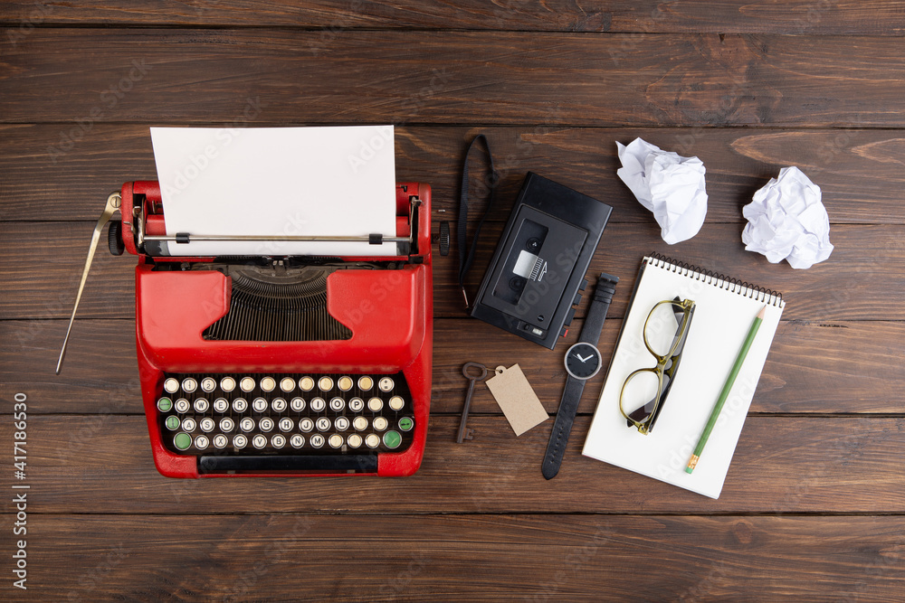 Journalism or blogging concept vintage typewriter on the wooden desk, top view