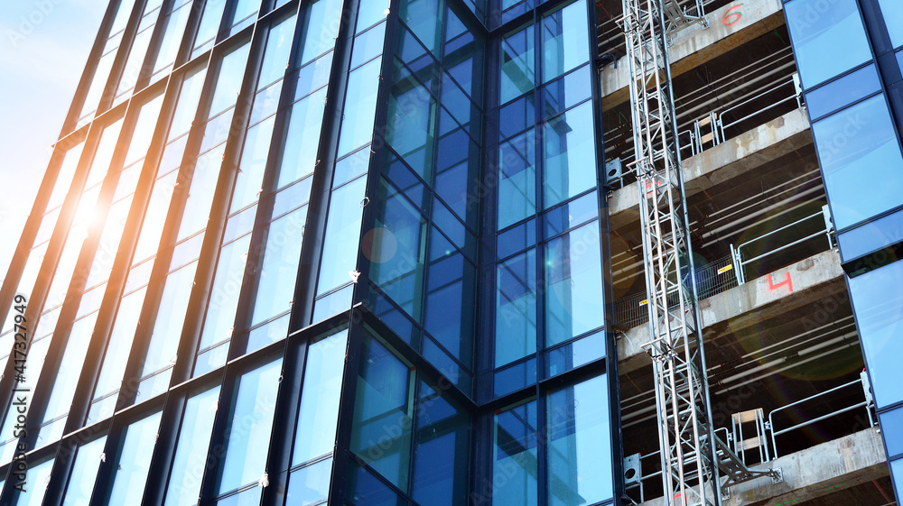 High-rise building under construction. Modern office building. Sunrise.