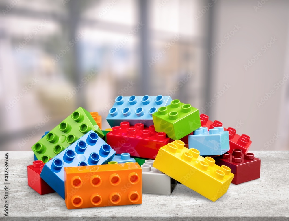 Colorful children building bricks on desk