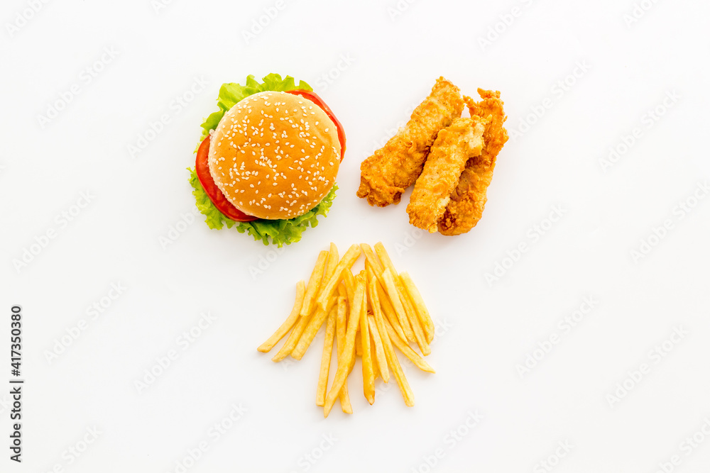 Delicious burgers with french fries and fried chicken. Flat lay, top view