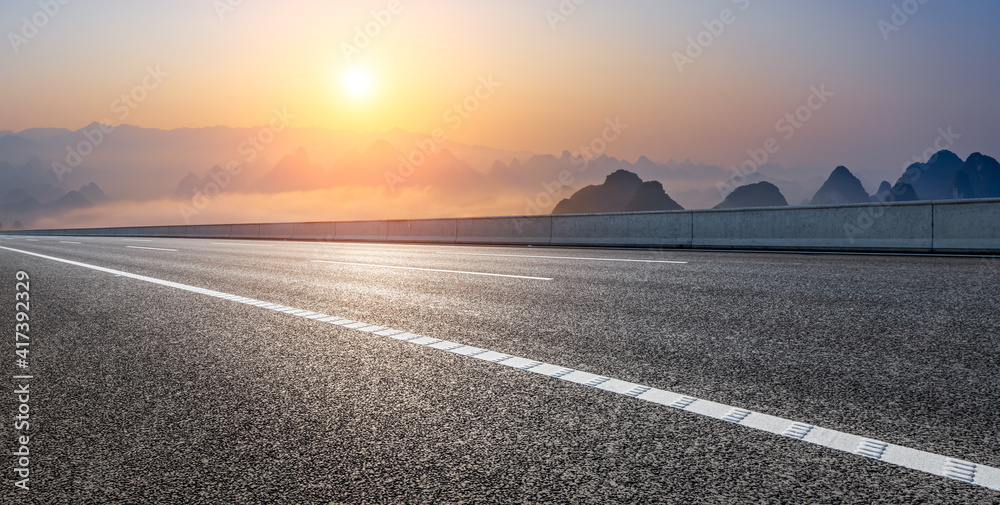 Empty asphalt road and beautiful mountains at sunrise in Guilin,China.