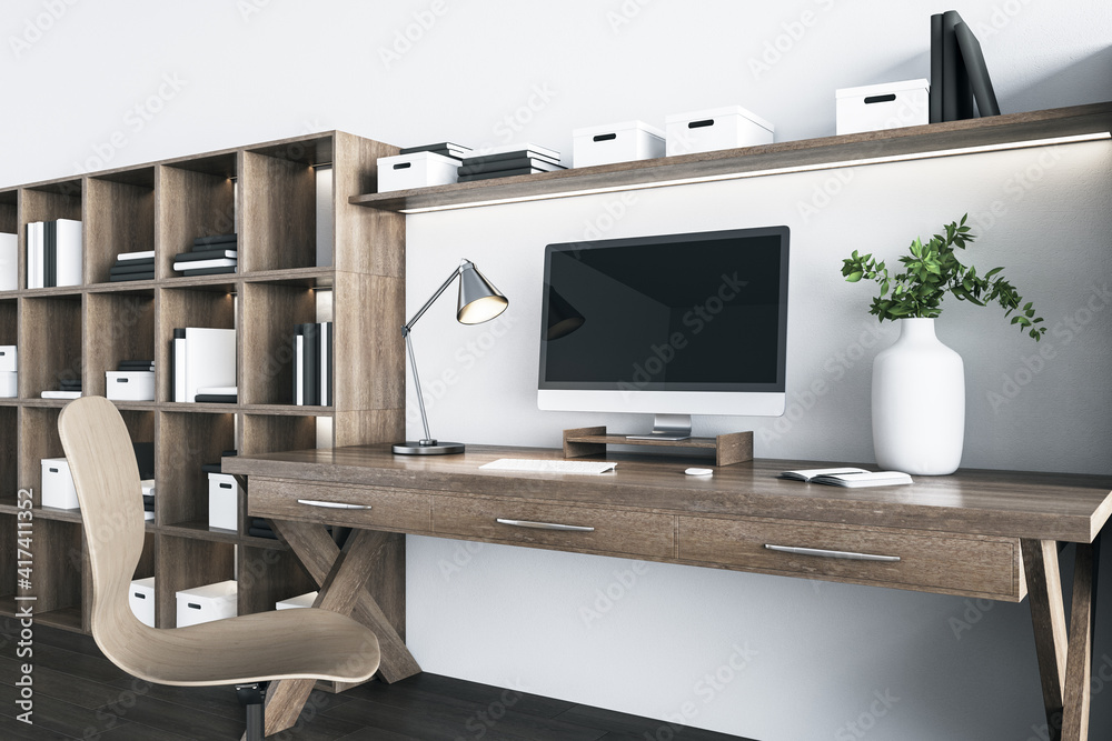 Black monitor screen on wooden table in eco style interior room with brown furniture