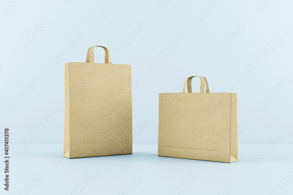 Blank recycled kraft paper bags with a space for your logo at blue background. Mock up