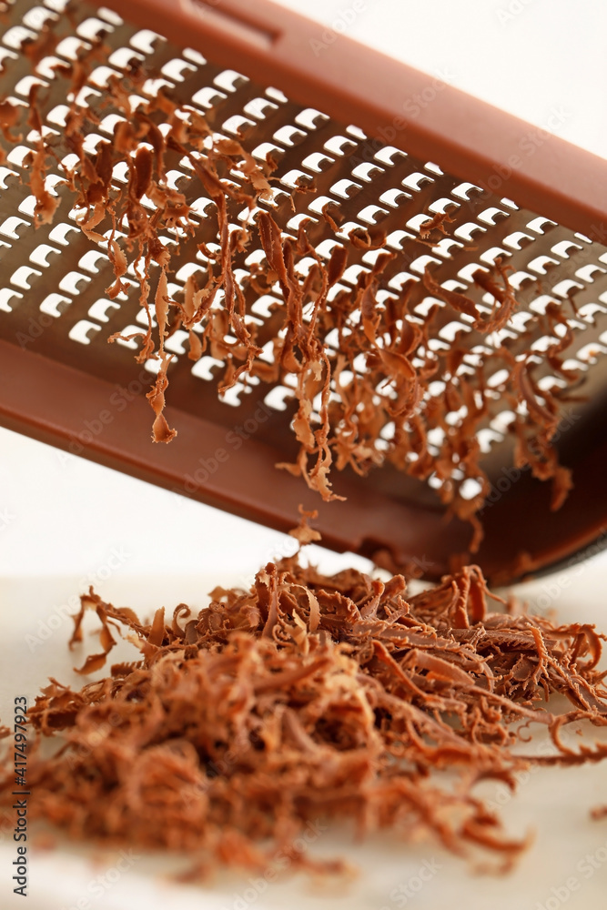 Sweet chocolate and grater, closeup