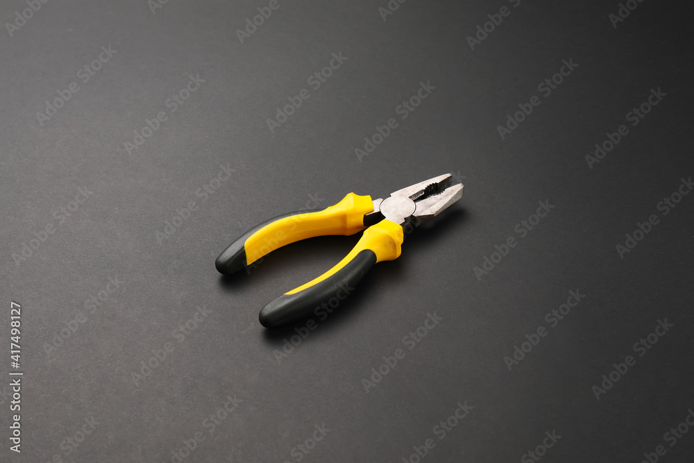 Builders pliers on dark background