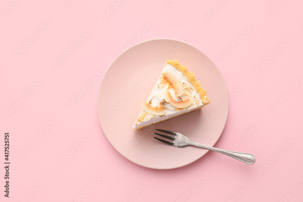 Plate with piece of tasty coconut pie on color background