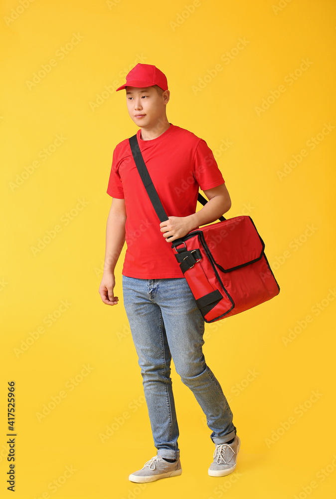 Courier of food delivery service on color background