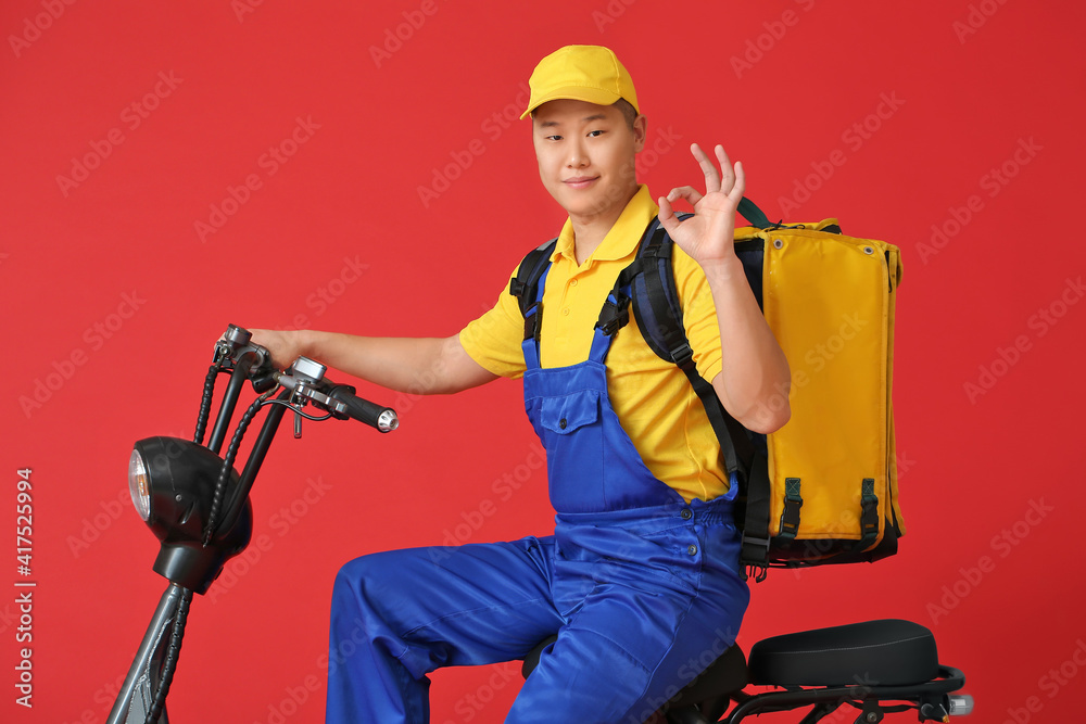 Courier of food delivery service showing OK on color background