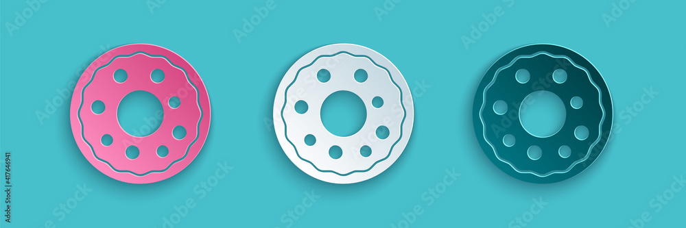 Paper cut Donut with sweet glaze icon isolated on blue background. Paper art style. Vector.