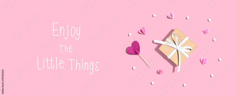 Enjoy the little things message with a small gift box and paper hearts