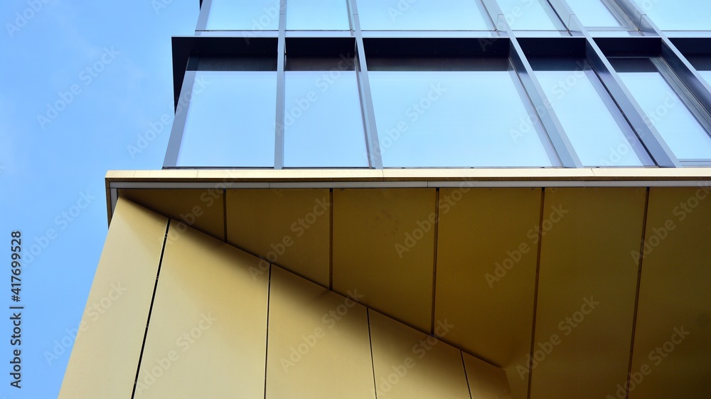 Fragment of glass and metal facade walls. Commercial office buildings. Abstract modern business arch