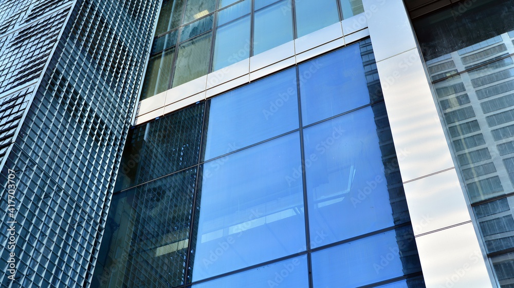 Fragment of glass and metal facade walls. Commercial office buildings. Abstract modern business arch