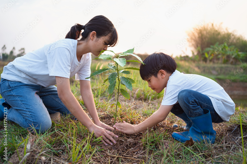 children helping planting tree in garden for save world. eco environment concept