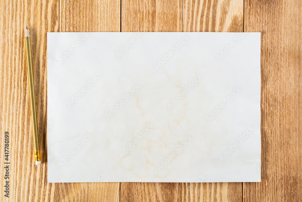 Sheet of paper lying on wooden table