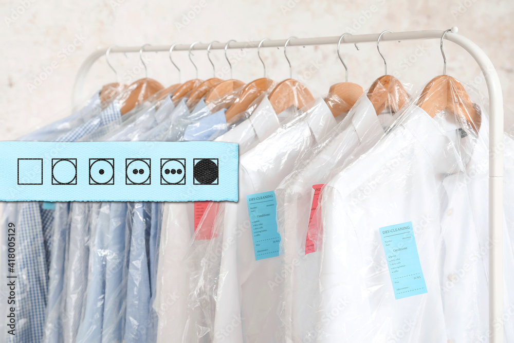 Young woman with clean laundry on color background