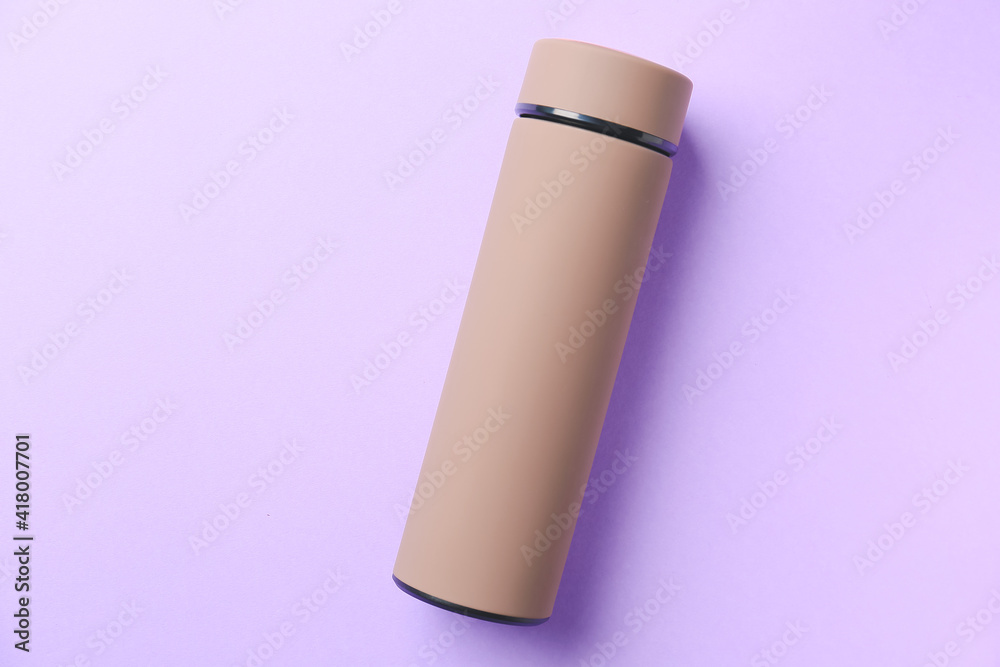 Modern thermos on color background