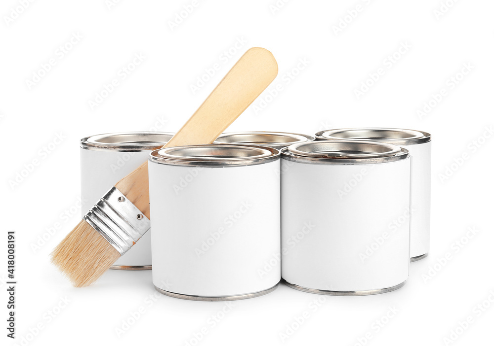 Cans of paint and brush on white background