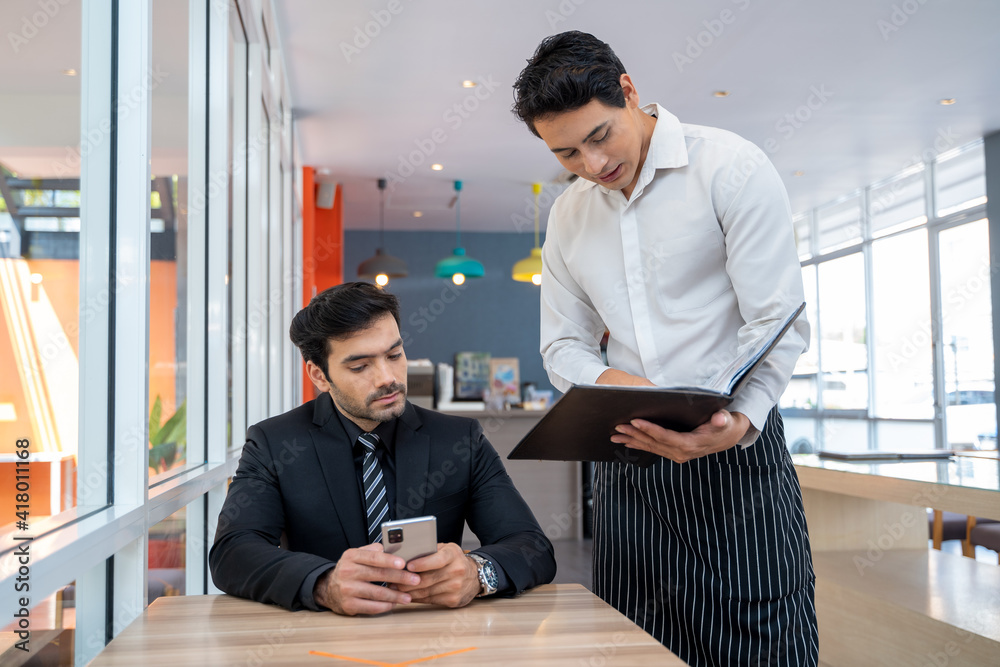 Staff taking orders from customer in coffee shop,Food and drink business concept.