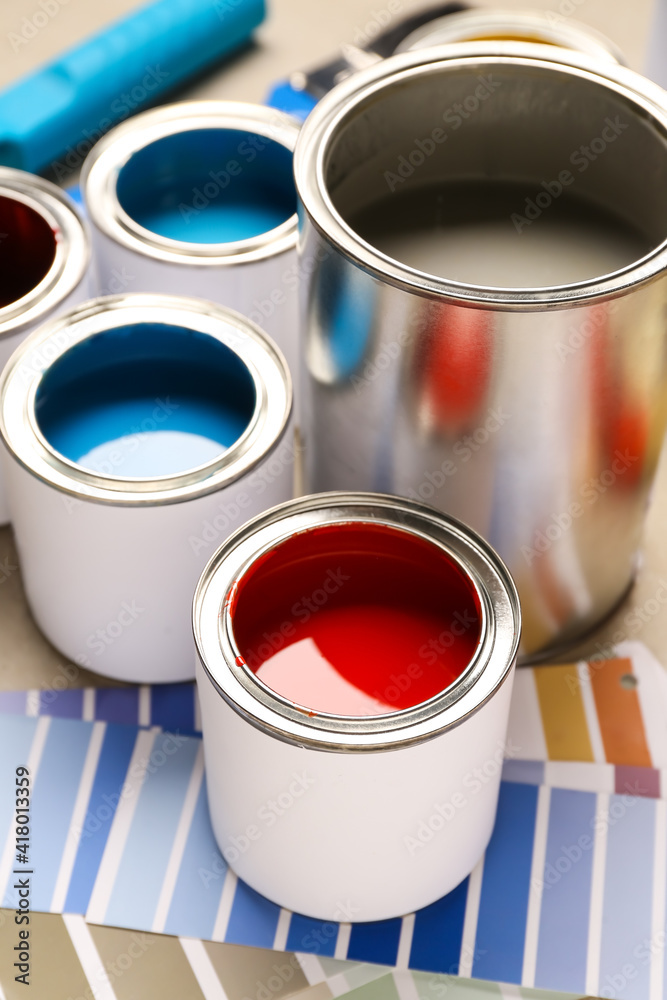 Cans of paints and palette samples, closeup