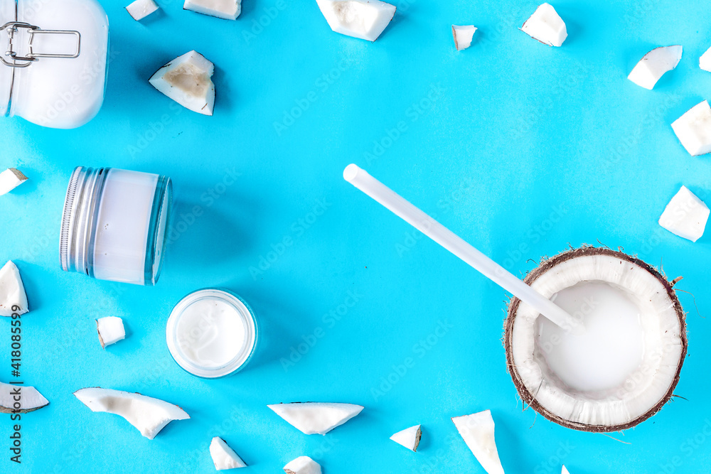 concept organic cosmetics with coconut on blue background top view