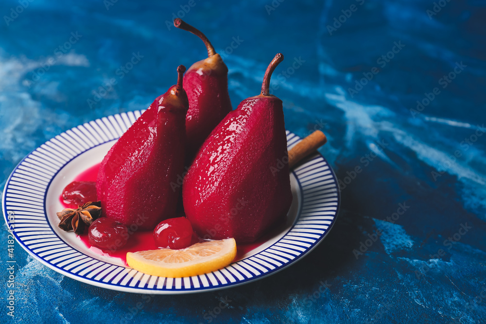 Plate with sweet poached pears in red wine on color background