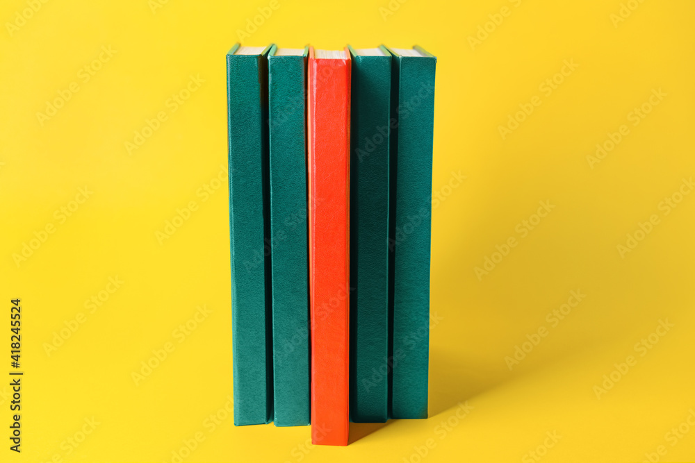 Blank books on color background