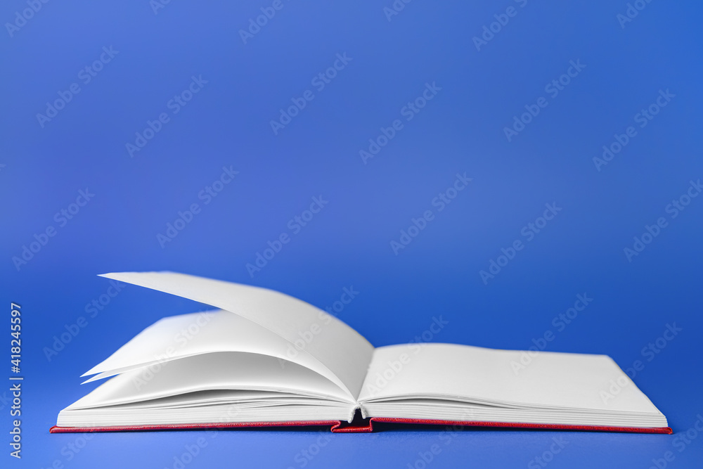 Blank open book on color background