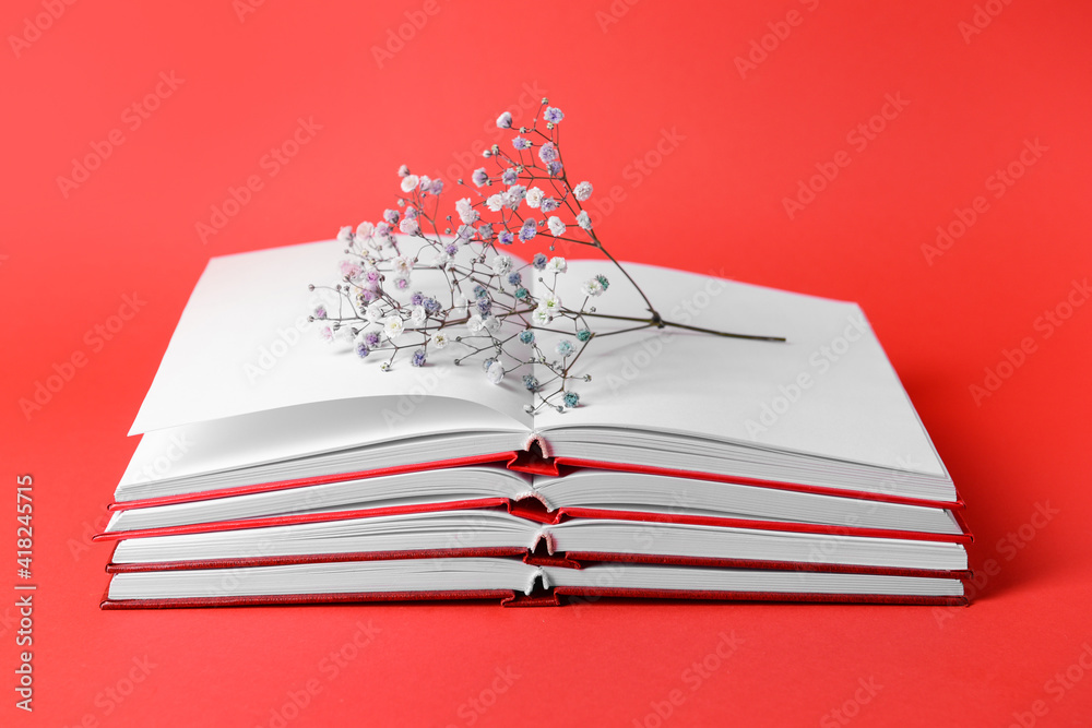 Blank books and flower on color background