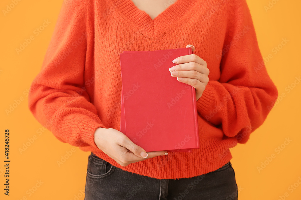 Woman with blank book on color background