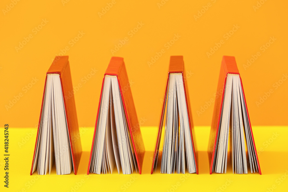 Blank books on color background