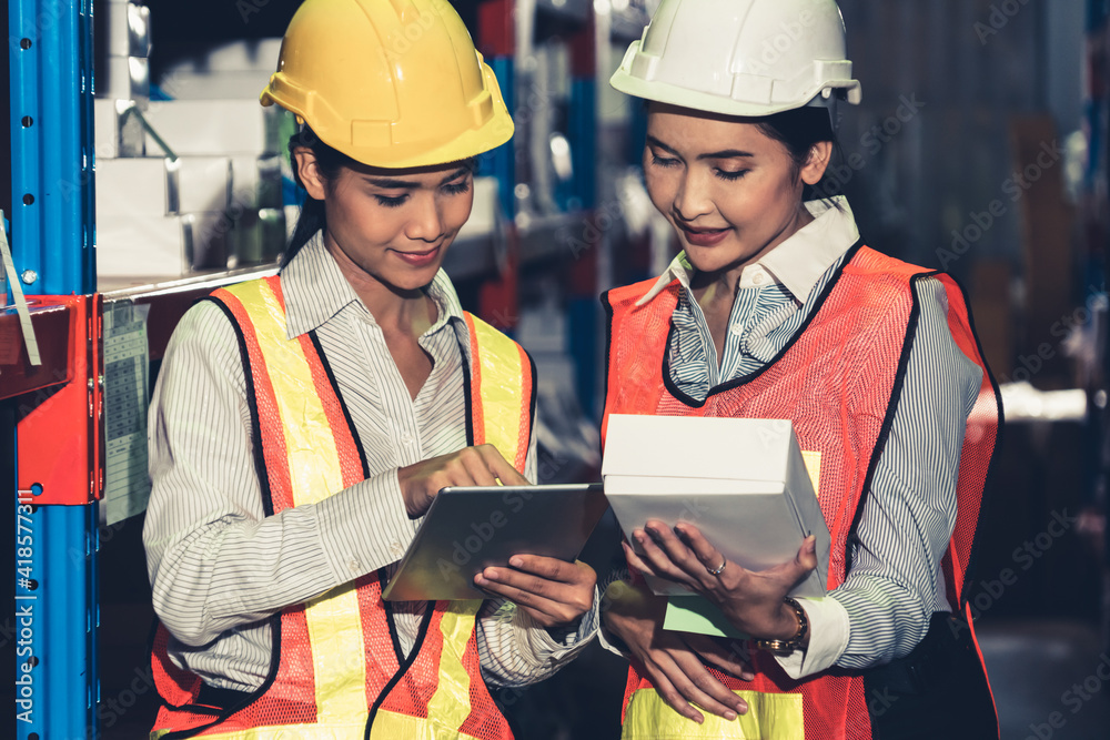 Female warehouse worker working at the storehouse . Logistics , supply chain and warehouse business 