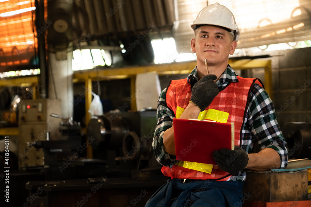 Manufacturing worker working with clipboard to do job procedure checklist . Factory production line 