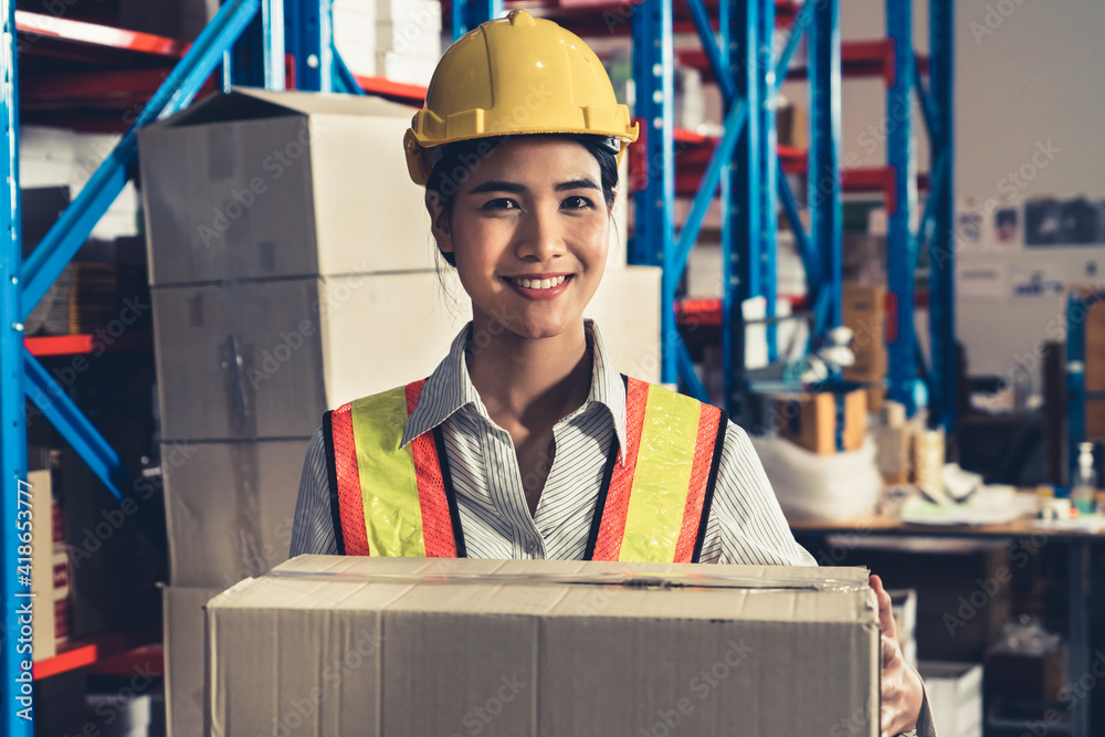 Portrait of young Asian woman warehouse worker smiling in the storehouse . Logistics , supply chain 