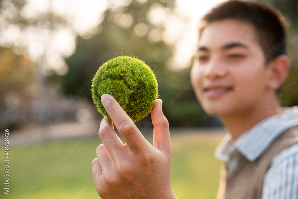 Asian teenager showing earth on hand, ecology and environment sustainable