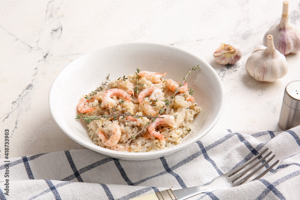 Plate with tasty risotto on light background