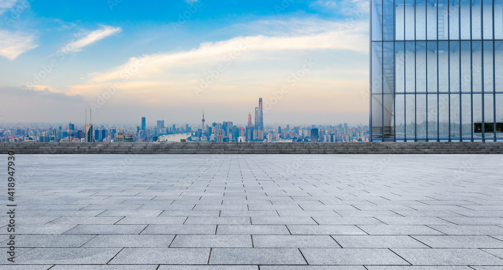 Empty square floor and city skyline with buildings at sunset in Shanghai.