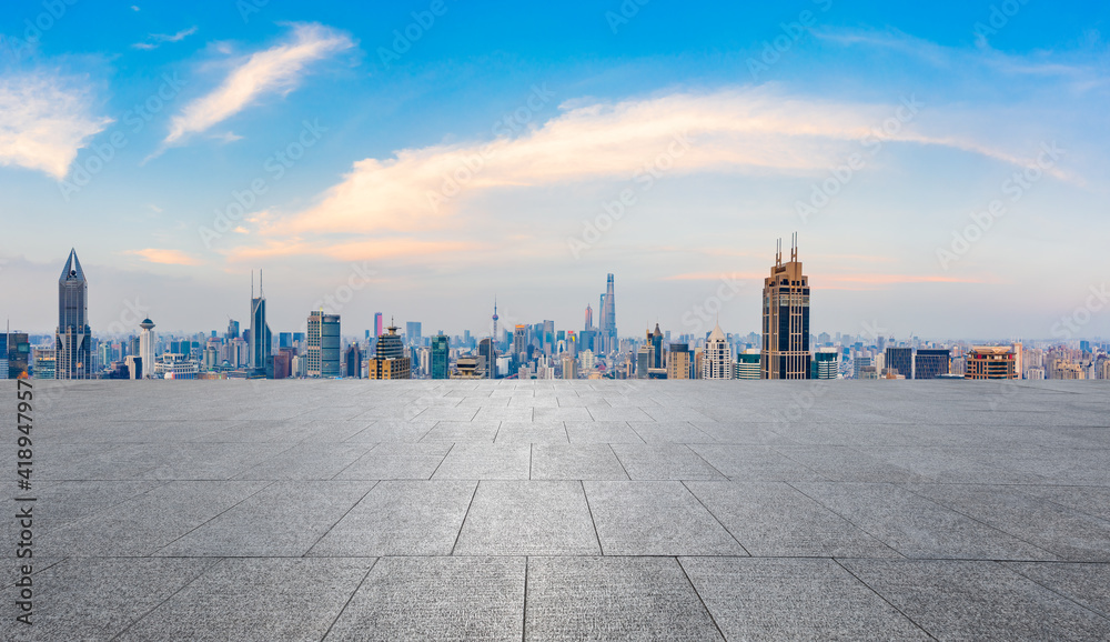 Empty square floor and city skyline with buildings at sunset in Shanghai.