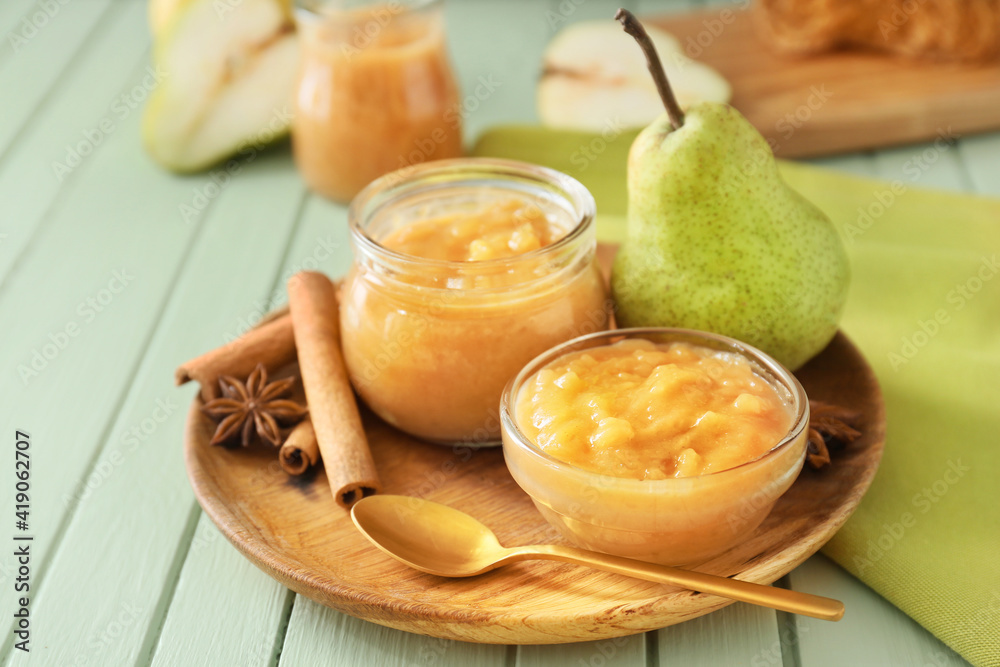 Tasty pear jam on wooden table