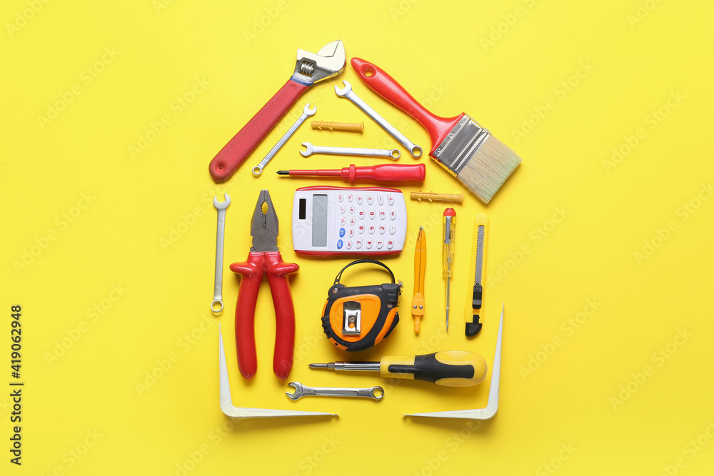 Composition with calculator and construction tools on color background