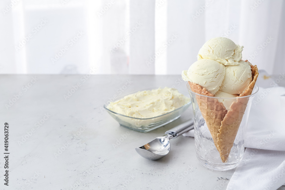 Glass with tasty banana ice-cream on table