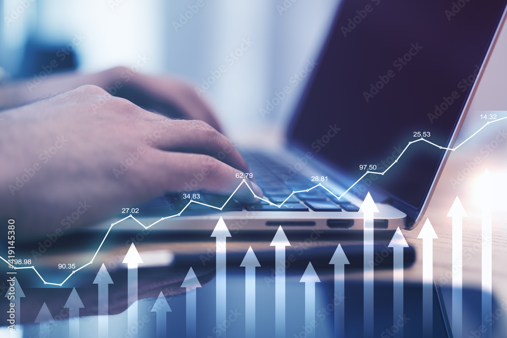 Online trade investing with financial chart with arrows and diagram on background with man hands typ