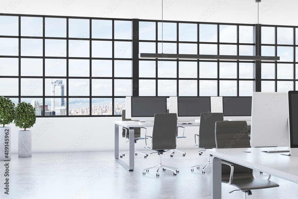 Sunny open space office with squared window with skyscrapers view, glossy concrete floor and modern 