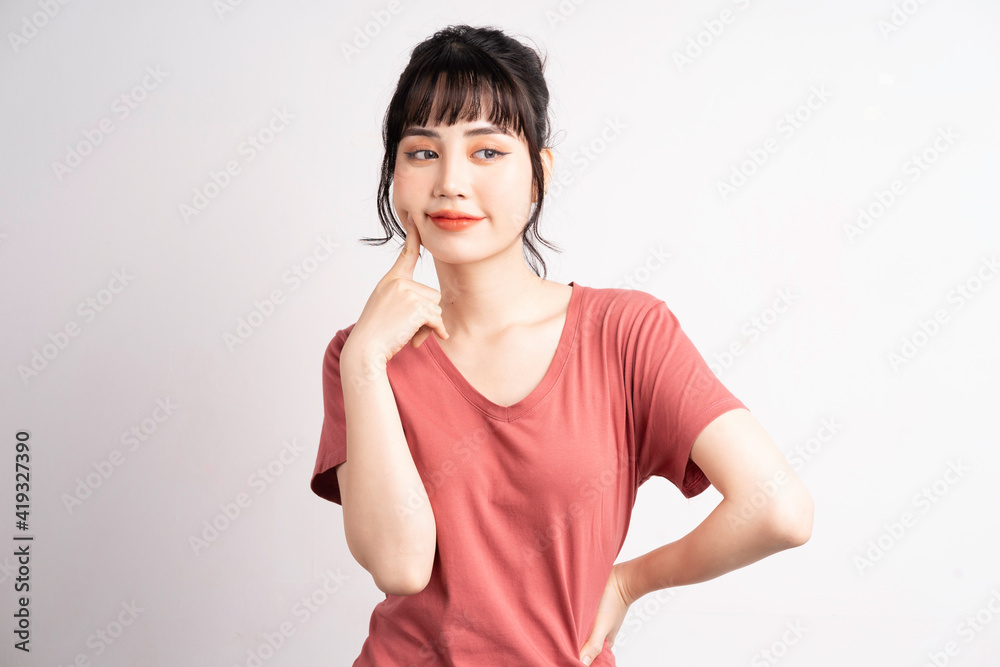 Young Asian woman posing on white background