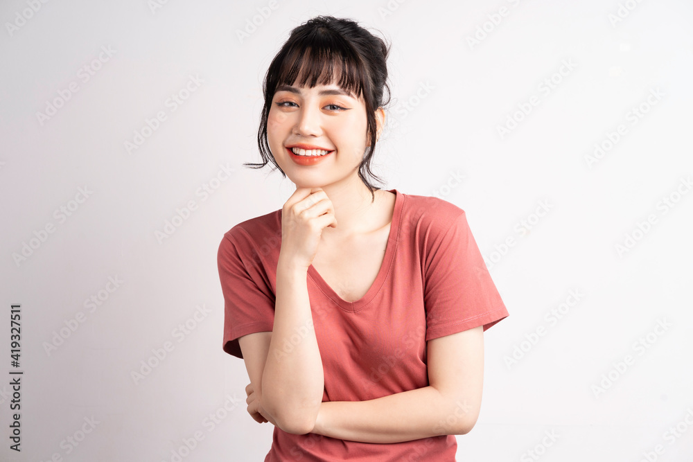 Young Asian woman posing on white background