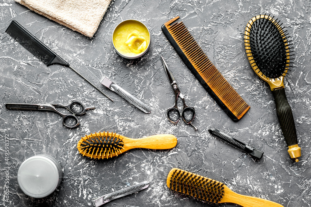 hairdressing concept with barber tools on gray background top view